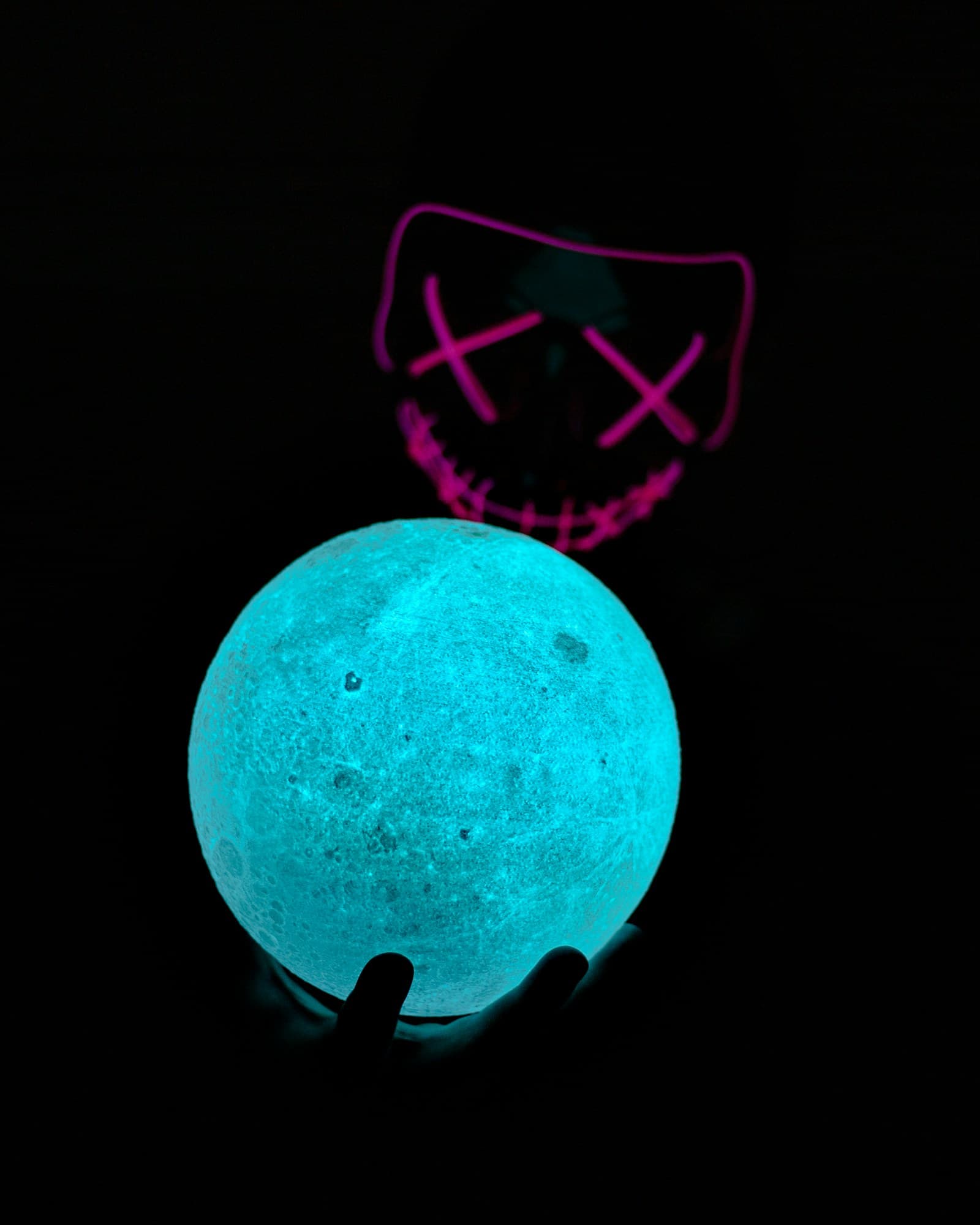 Glowing spherical lithophane lamp revealing an image in warm light