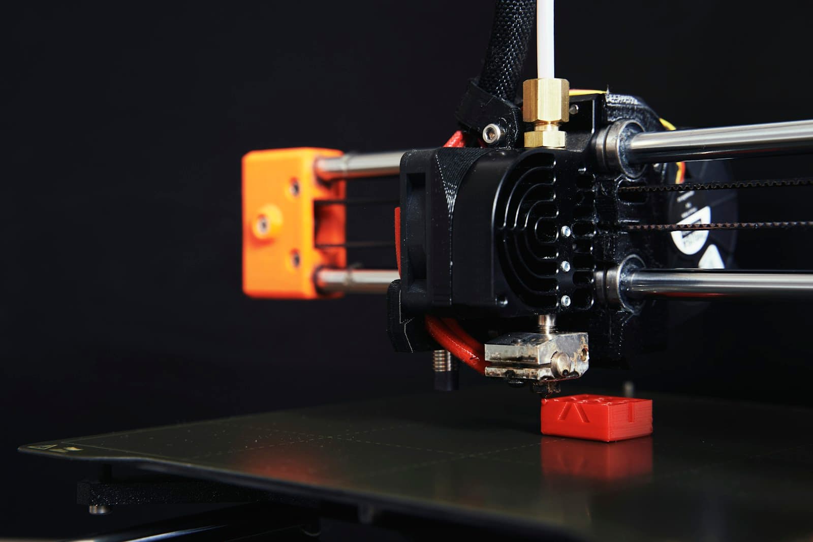 Close-up of a 3D printer building a piece layer by layer in the Craftmandu studio